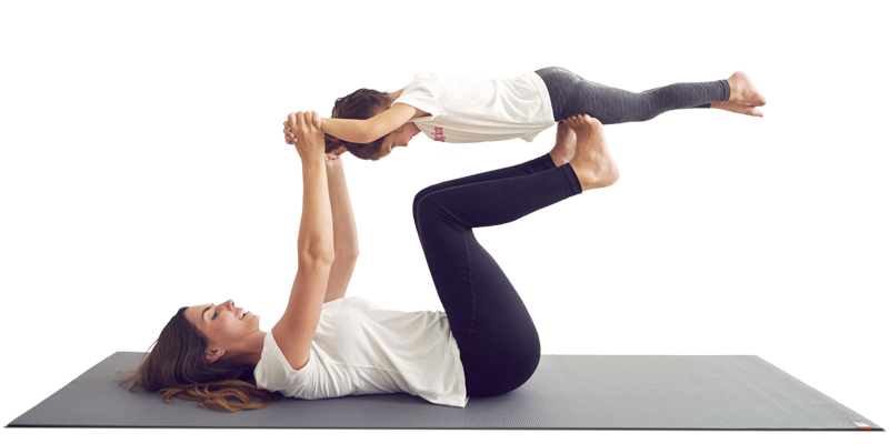 Mom lifting daughter on yoga mat